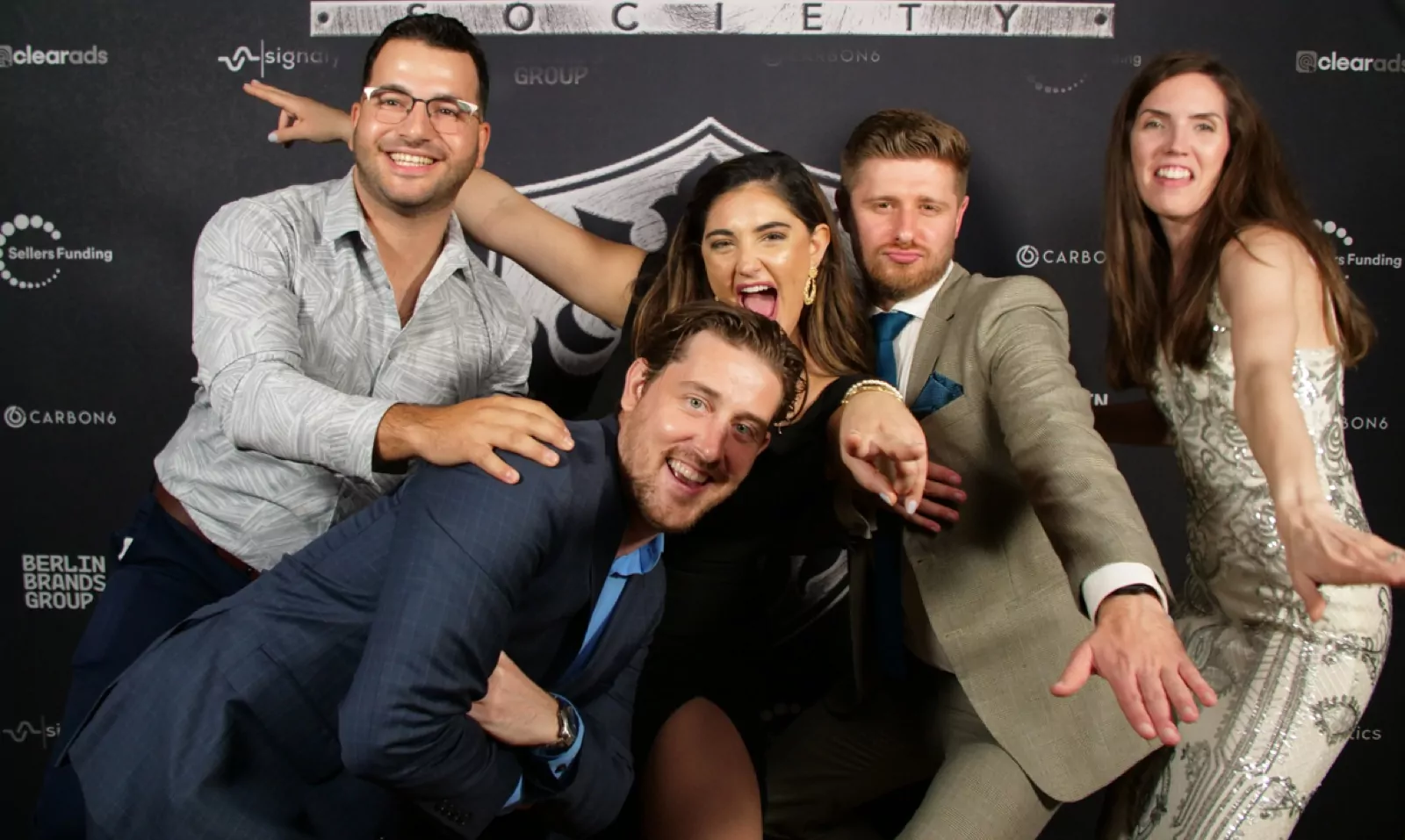 Group photo at Elite Seller Society backdrop